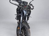 a black motorcycle that is parked on a white floor