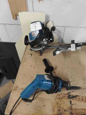 two electric tools sitting on a table in a room