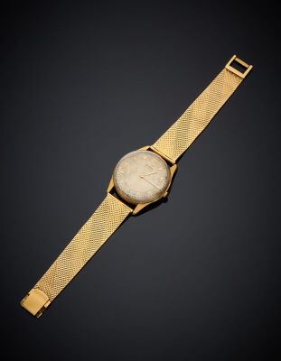 a gold watch with a white dial on a black background