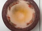 a bowl of liquid sitting on top of a white counter