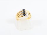 a close up of a gold ring with sapphires and diamonds