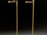 a pair of brass plated floor lamps