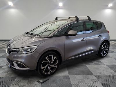 a silver car is parked in a room with a checkered floor