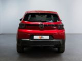 the back end of a red car in a white room