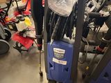 a close up of a blue and black vacuum cleaner on a floor