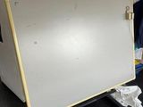 a dry eraser on a cart in a room