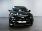 the front of a black suv parked in a showroom
