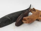 pair of carved wooden animal figurines on a white surface