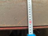 a close up of a measuring tape on a piece of wood