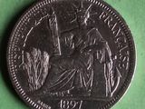an image of a coin on a green surface with a picture of a woman sitting on a chair