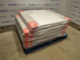 a stack of boxes on a pallet in front of a wall