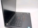 a laptop with a black keyboard on a white surface