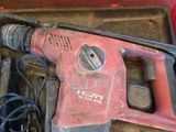 a drill in a tool box with a cord in it
