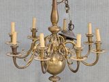 a bird perched on a chandelier with candles on it
