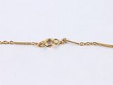 a gold chain bracelet with a heart charm on it