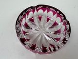 a pink glass bowl with a white flower on it