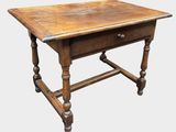 an old wooden table with a drawer on top of it