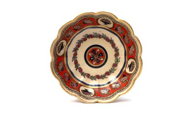 a red and gold plate with a floral design on it