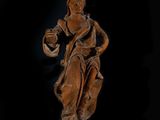 an old wooden statue of a woman holding a bowl