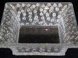 a clear glass bowl with a design on it