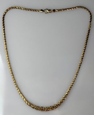 a gold necklace with a twisted rope on a white background