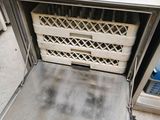 an open oven with a basket inside of it