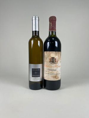 two bottles of wine sitting next to each other on a table