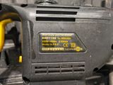 a close up of a power tool with a yellow handle