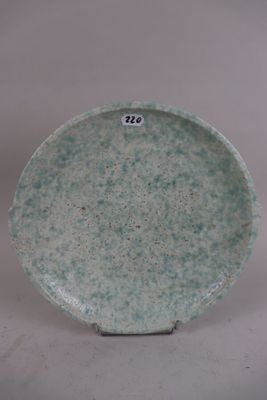 a green plate with a number on it on a white surface