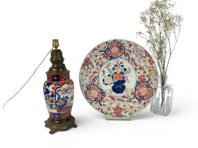 two vases and a plate sitting next to each other
