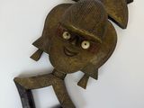 une image d'un masque en bois accroché au mur