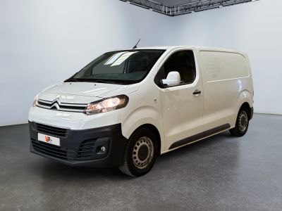 the white van is parked in the large room of the building