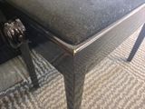 a black bench with a black cushion on it
