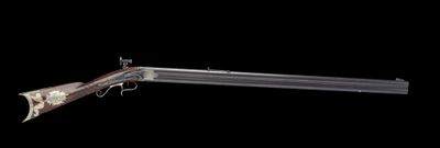 an old gun with a wooden barrel is shown against a black background