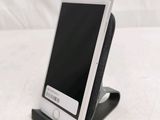 a cell phone that is sitting on top of a stand