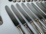 a lot of knives and spoons on the table