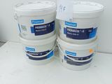 three buckets of paint sitting on top of a white table