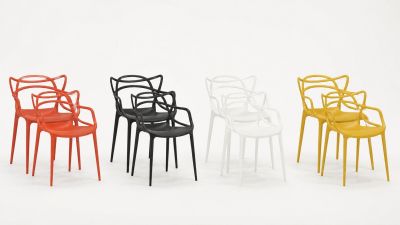 four different colored plastic chairs in a row against a white background