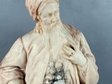 statue of an old man with a beard and a white robe