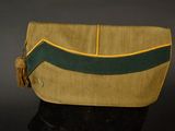 yellow and green purse with tassel on black surface