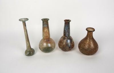 several different colored vases are lined up on a white surface