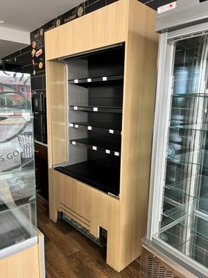 a display case in the middle of a store with glass doors