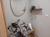 a mirror on the wall above a bench in a bathroom