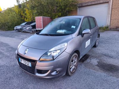 une voiture argentée garée dans un parking à côté d'un bâtiment