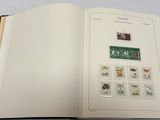 an open book with stamps on it sitting on a table
