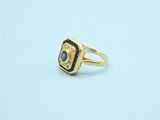 a close up of a gold ring with a blue stone