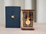a small clock that is sitting next to a small box