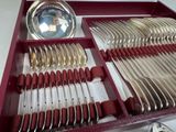 a red tray with silverware in it on a table