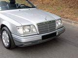 a silver car that is driving down the street