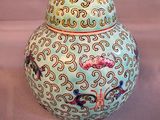 a vase with a lid that has a design on it